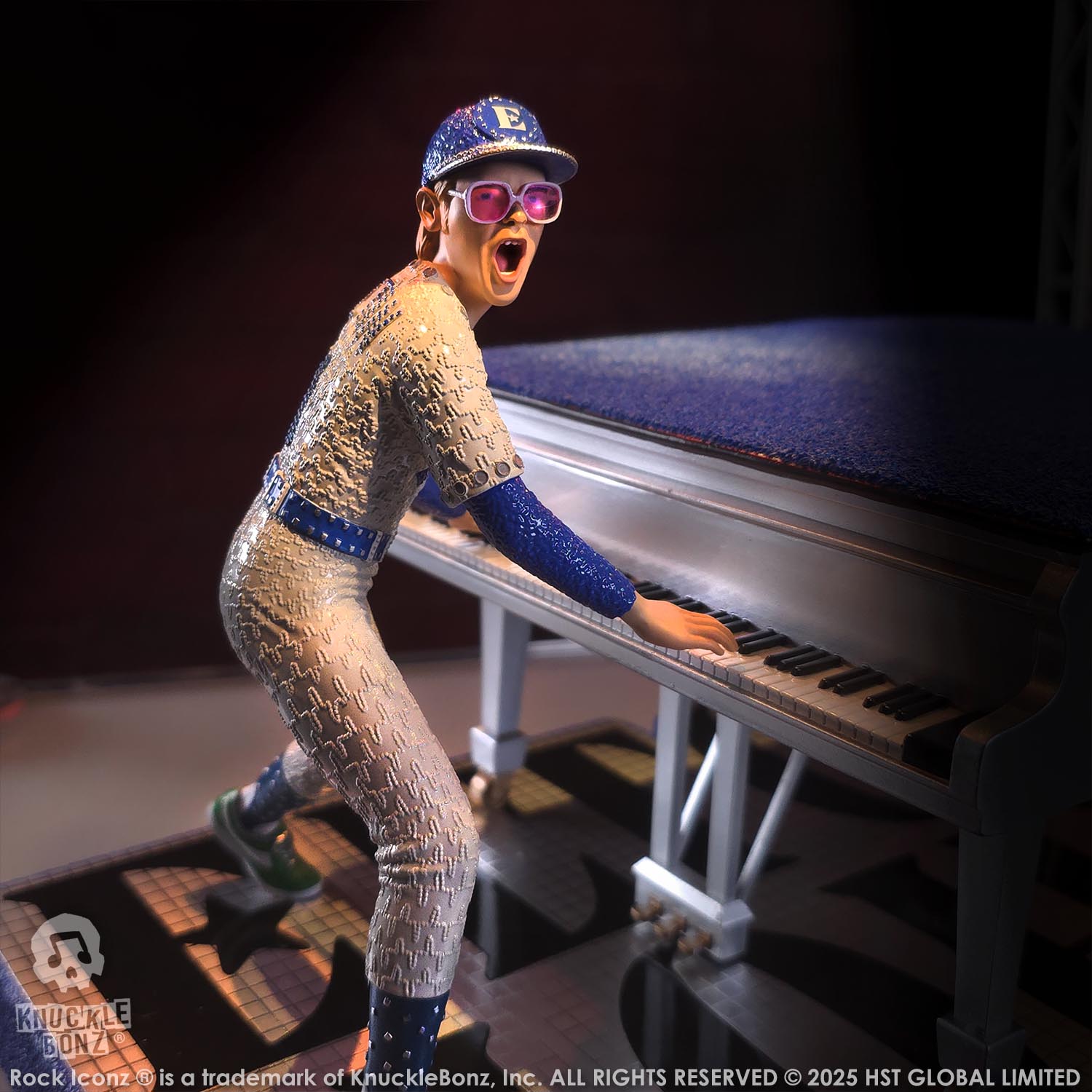 Statue of Elton John with a grand piano in a baseball uniform with a dark background